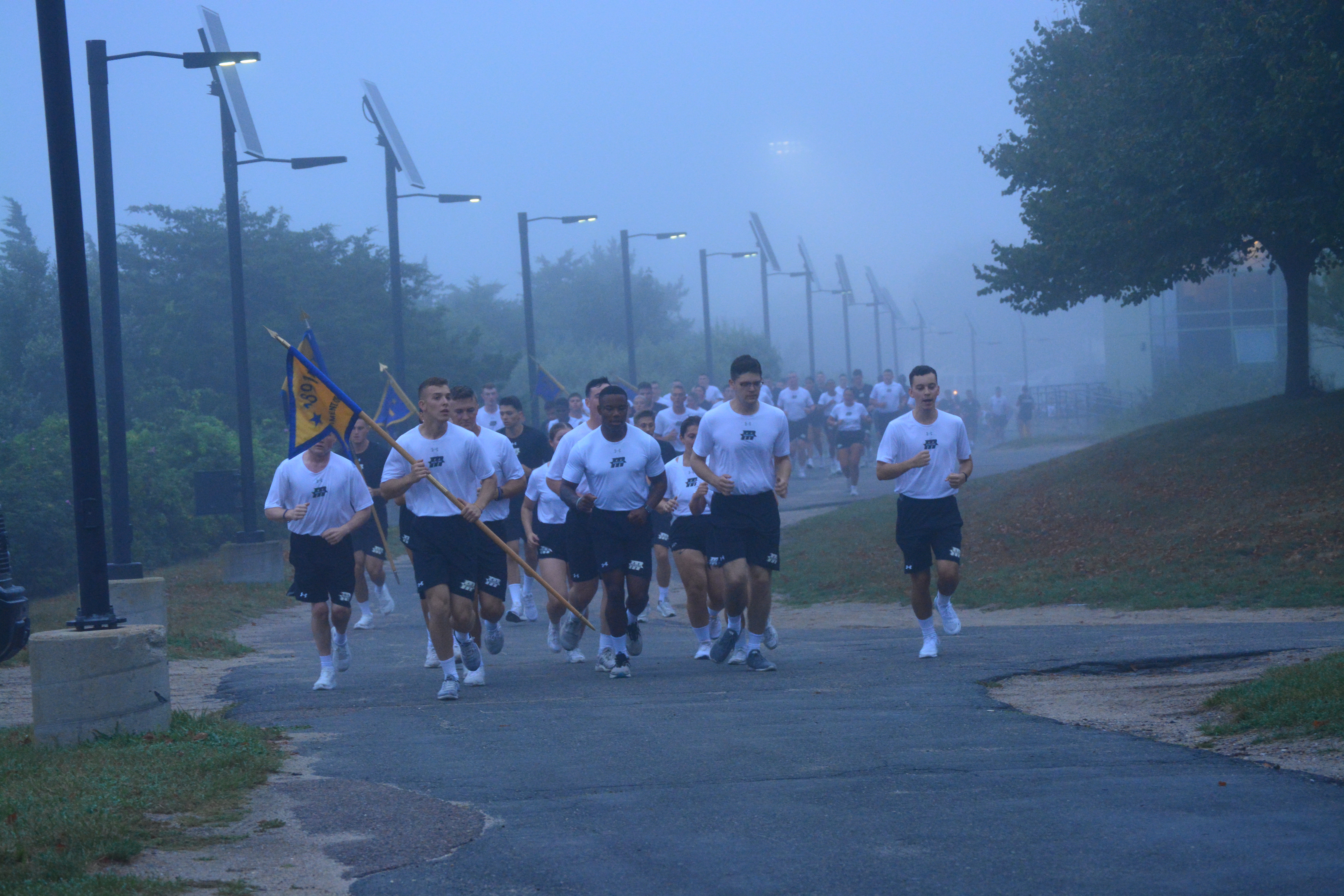 1/C Lydell leads the regimental staff in a cadence