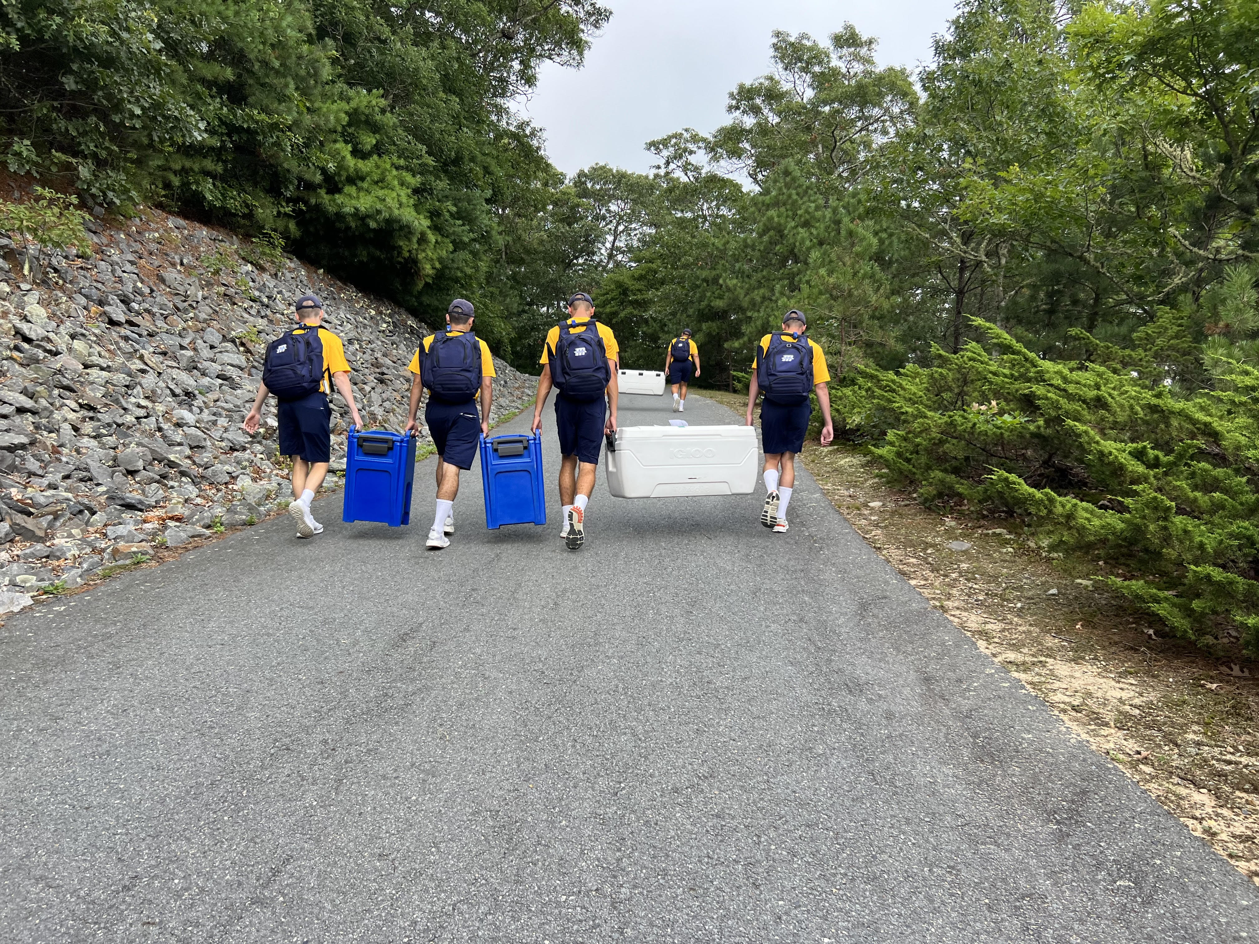 1st Co C/C's work together to carry their lunch coolers