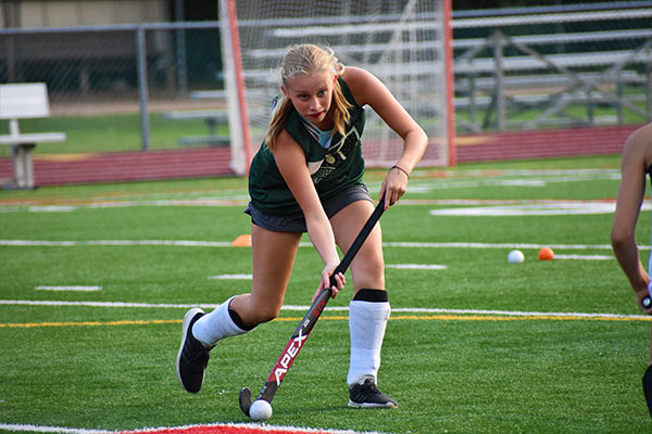 Child playing field hockey