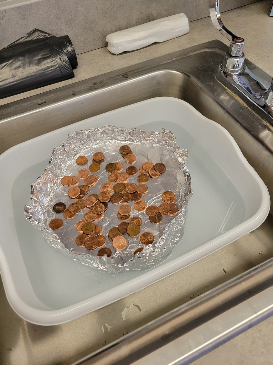 student testing lifeboat with pennies