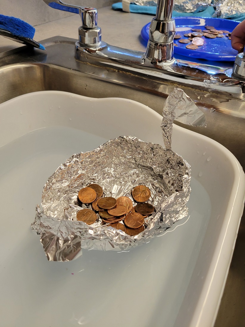 student testing lifeboat with pennies