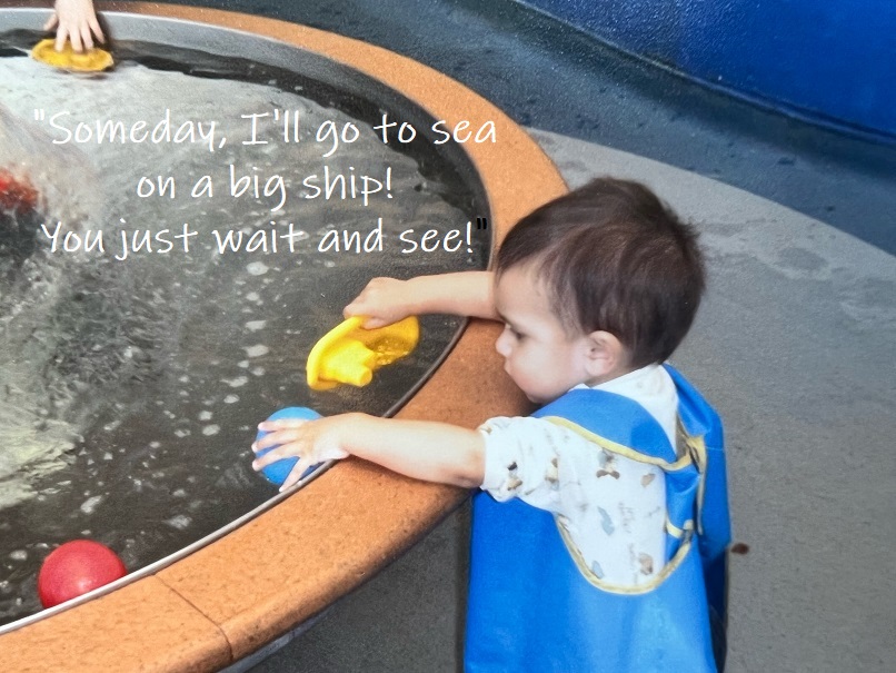 baby Ethan playing with a toy boat