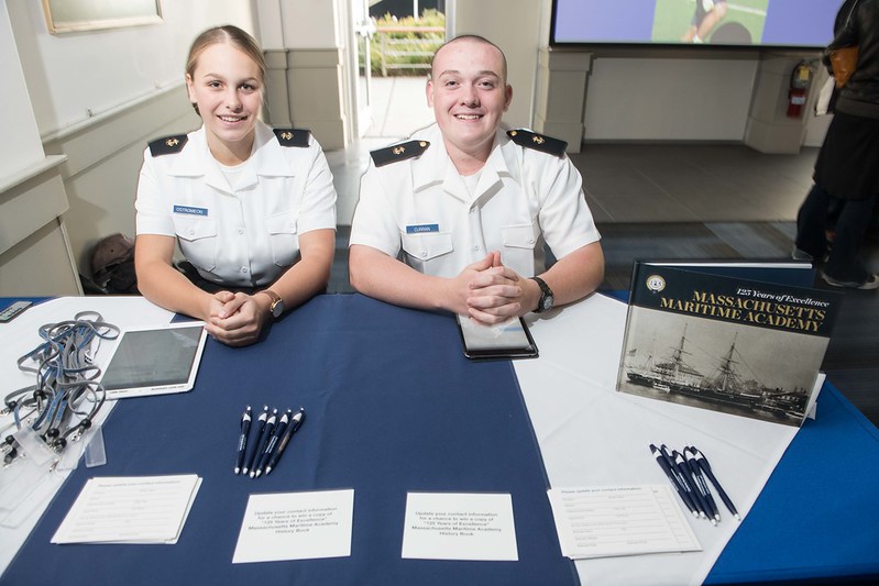 cadets at a table with the history book