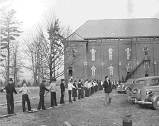 a human chain passes books to a library