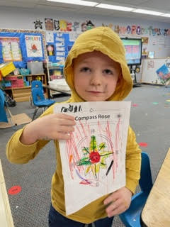 preschool child holding colored compass rose