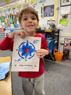 preschool child holding colored compass rose