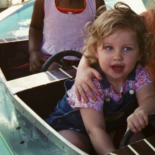 Chloe is in a boat at an amusement park
