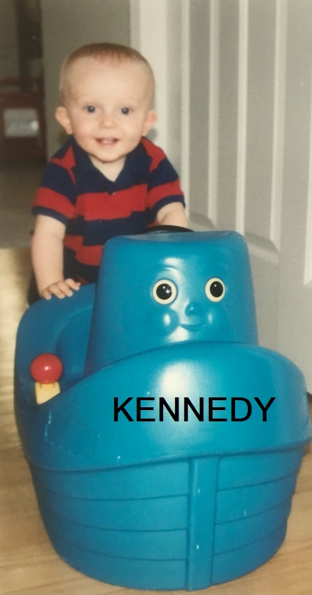 baby Daniel with a blue plastic boat