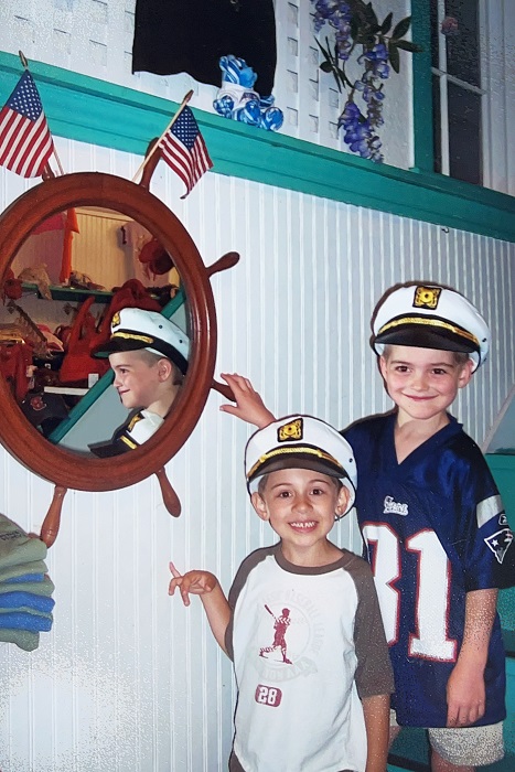 liam and his brother standing on stairs with sailor hats