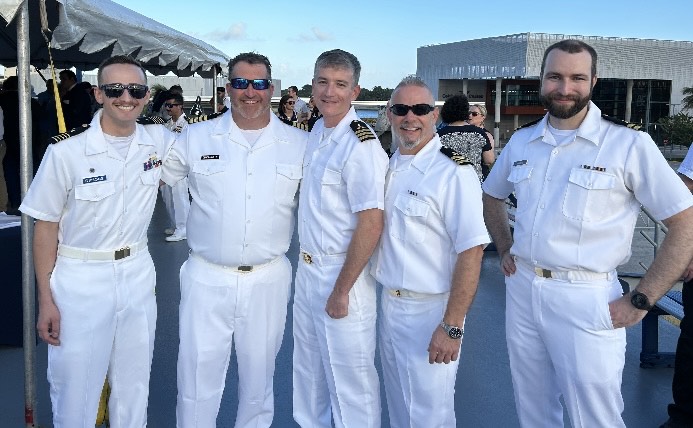 engineering team in dress white uniforms