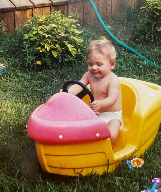 baby Hunter in a tiny boat in his yard