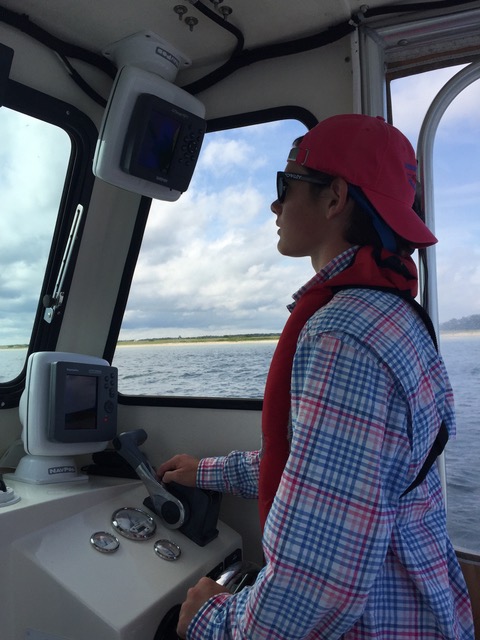 teenage Ian driving a boat