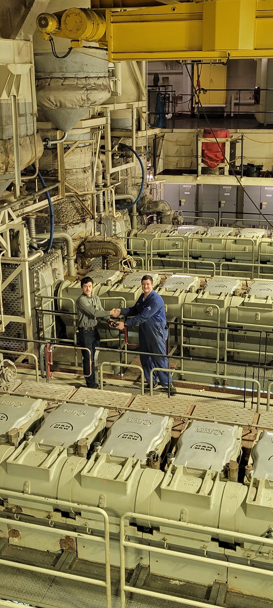 cadet in massive engine room on ship