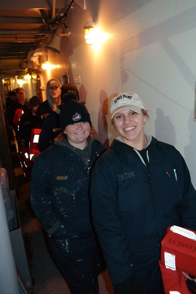 cadets carrying lifejackets on deck