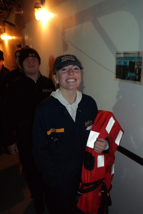 cadets carrying lifejackets on deck