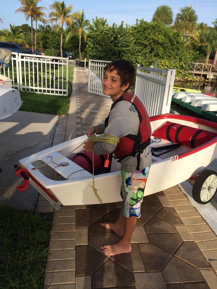 lucas near a white boat