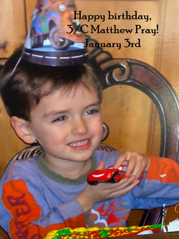 boy with party hat holding car