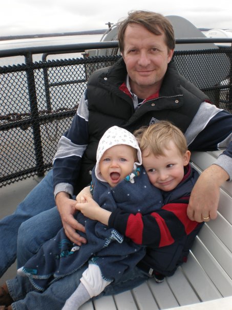 Michael with Dad and sister on deck of ship