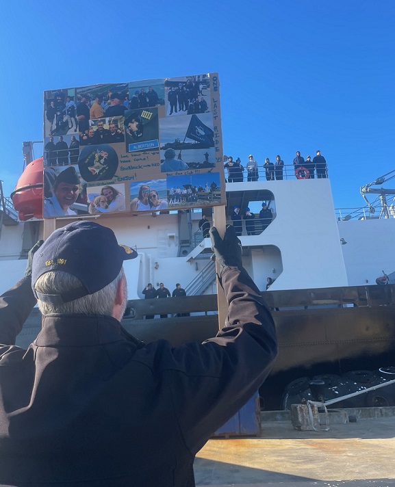 Admiral holding sign