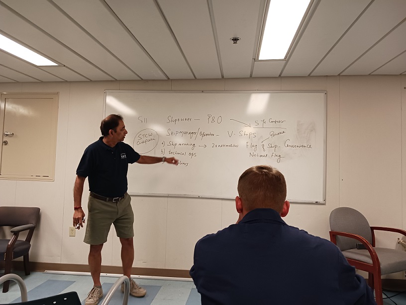 professor in front of white board