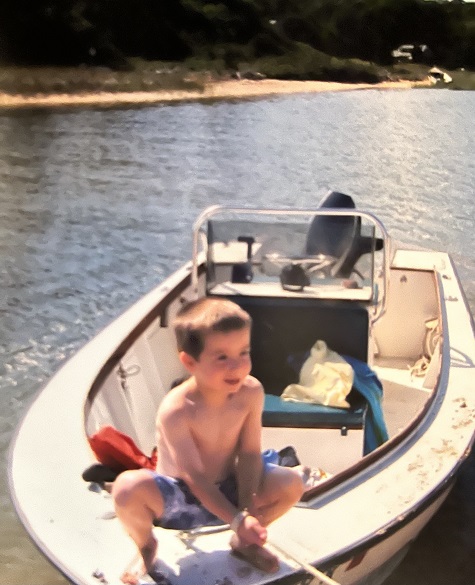 young Nick on a boat