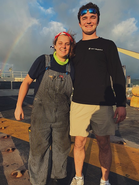 Paige and Hugh in front of a rainbow