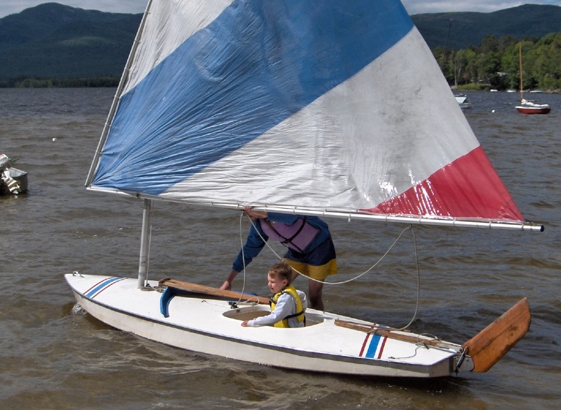baby Robert sitting in a sailboat