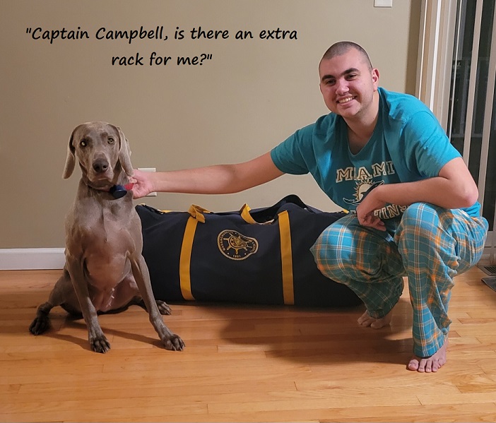 cadet kneeling with dog