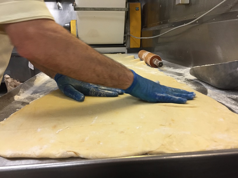 touching dough with hands