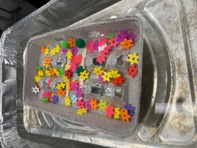 student made lifeboat in  small basin of water