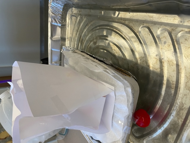 student made lifeboat in small basin of water