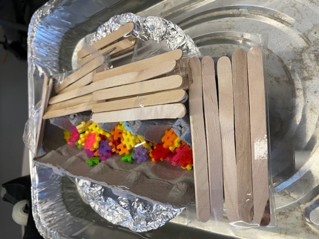 student made lifeboat in  small basin of water