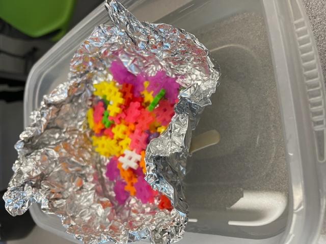 student made lifeboat in small basin of water