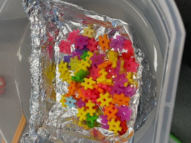 student made lifeboat in small basin of water