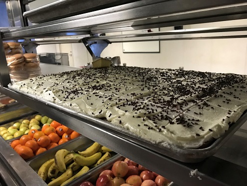 mess deck shelf with fresh fruit and cake