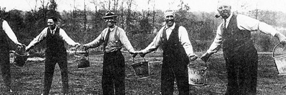 antique photo of men passing buckets