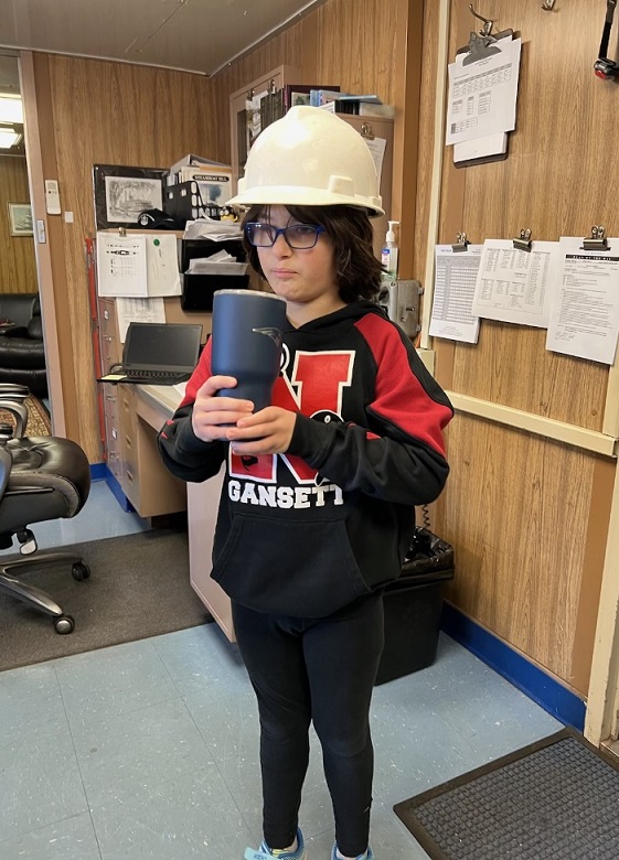 son tries on captains hat