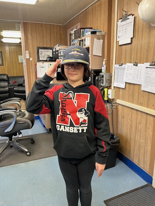 son tries on captains hat