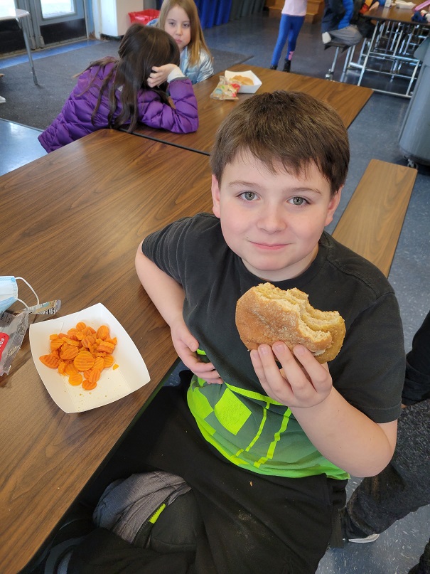 young students eat chicken patties