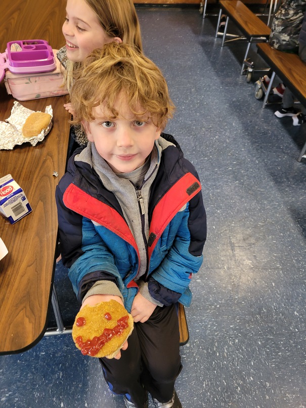 young students eat chicken patties