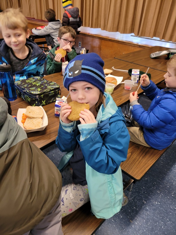 young students eat chicken patties