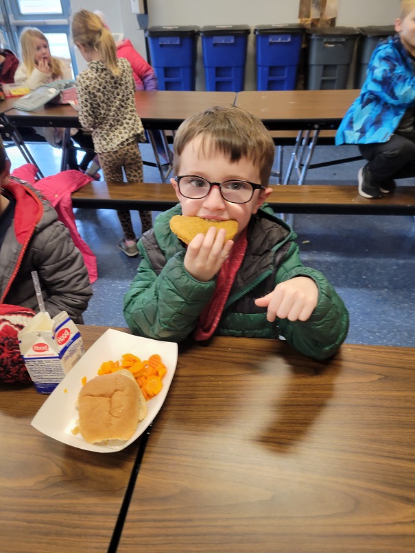 young students eat chicken patties