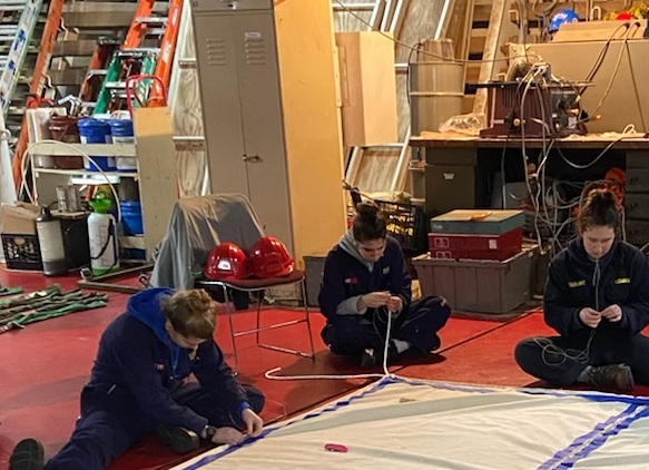 close up of cadets sewing canvas