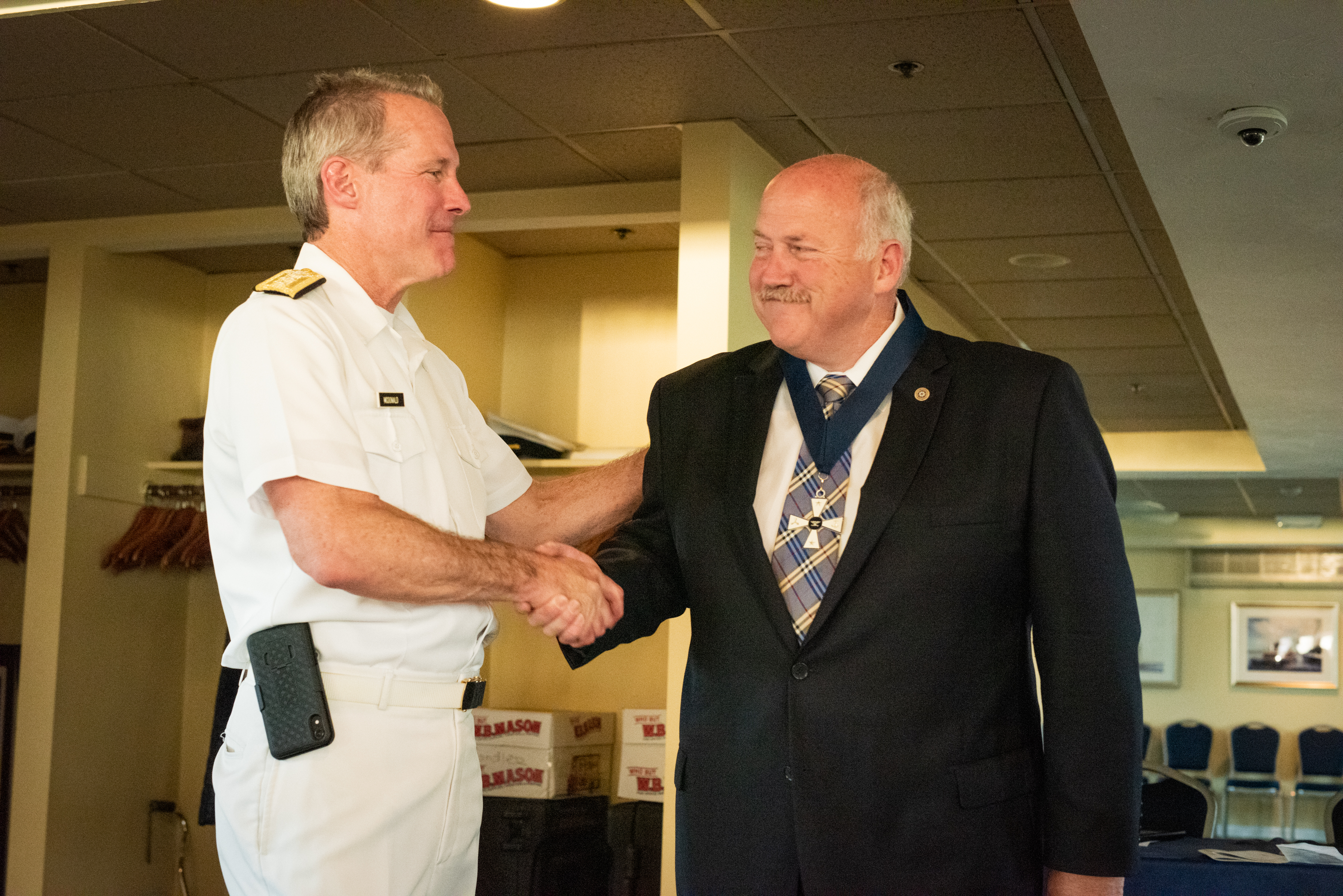 admiral shaking hands with donor