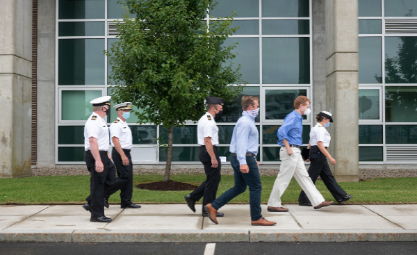 staff walking on campus with masks on