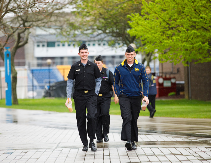 cadets walking on campus in rain