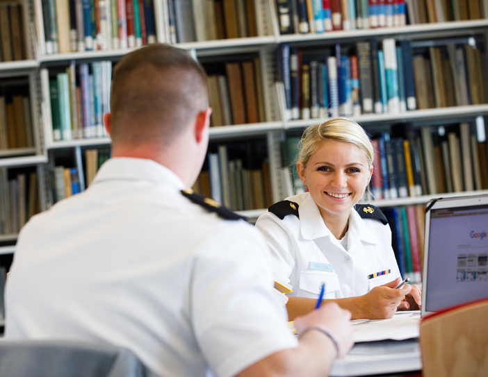 student smiling in the library