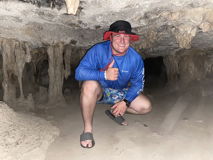 cadet crouching at cave