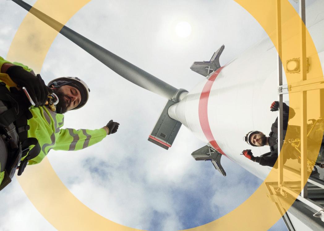 men working under a wind turbine