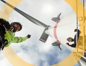 men working under a wind turbine